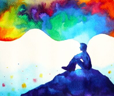 Person sitting on a hill, thinking in colour